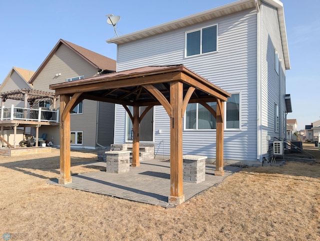 back of property with a gazebo, a patio area, and a pergola