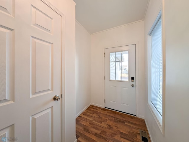 entryway featuring dark wood finished floors, visible vents, crown molding, and baseboards