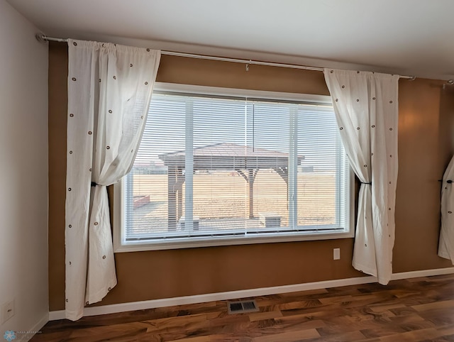 room details with wood finished floors, baseboards, and visible vents