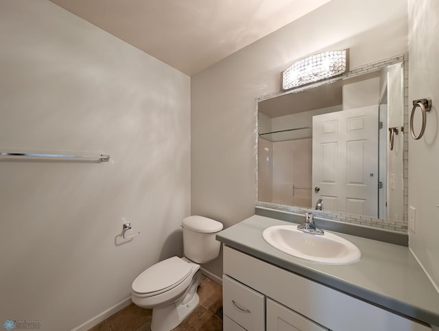 bathroom featuring tile patterned floors, toilet, vanity, and baseboards