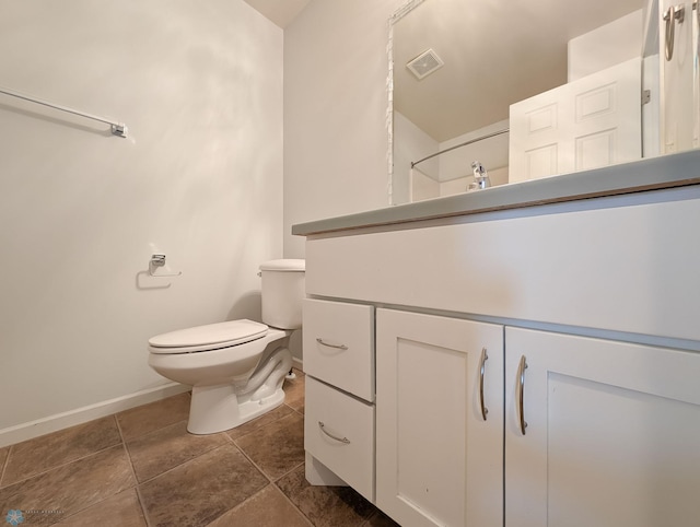 bathroom featuring tile patterned floors, visible vents, toilet, baseboards, and vanity