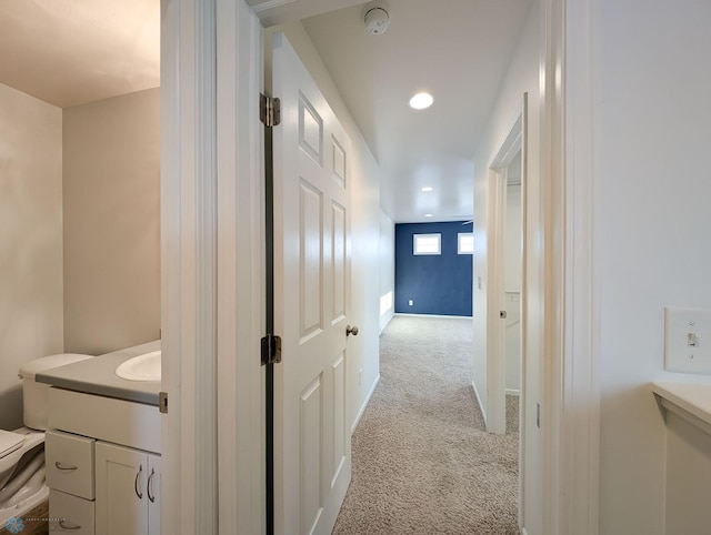 corridor with recessed lighting and light colored carpet