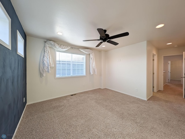 spare room featuring carpet flooring, recessed lighting, a ceiling fan, and baseboards