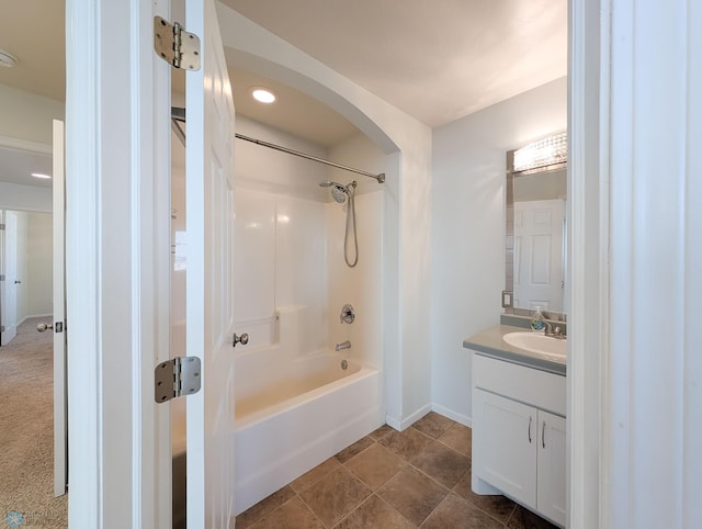 bathroom featuring vanity, baseboards, tile patterned flooring, and shower / washtub combination