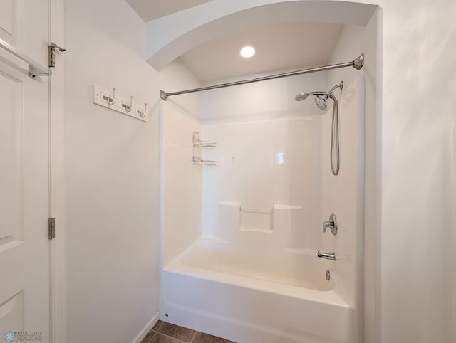 bathroom with tile patterned floors and shower / bath combination