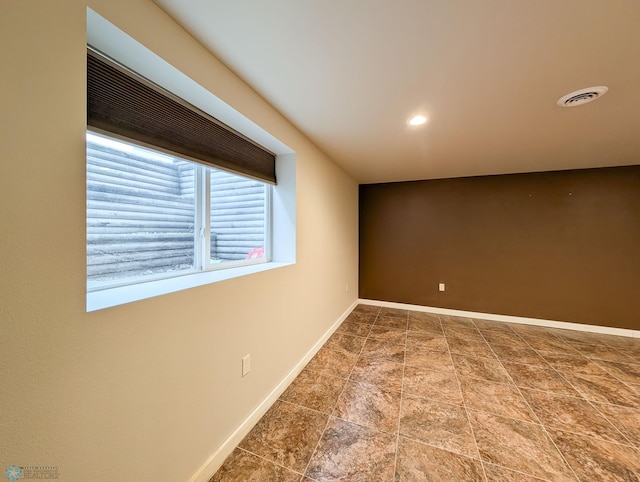 spare room with recessed lighting, visible vents, and baseboards