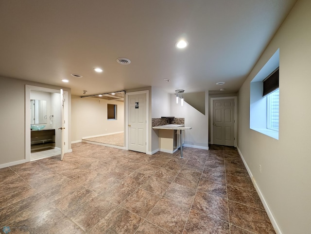 unfurnished living room with recessed lighting, visible vents, and baseboards