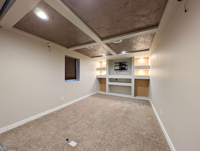 finished basement with built in features, baseboards, and carpet flooring