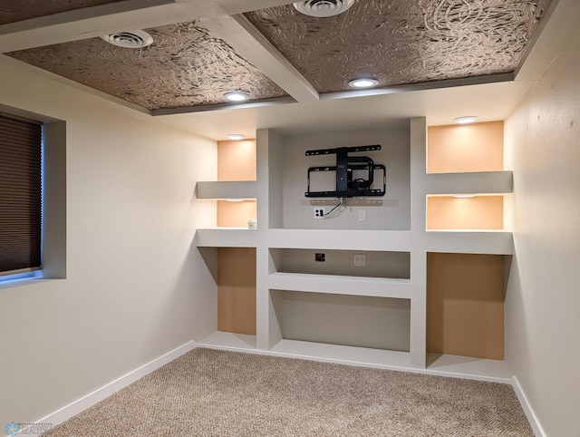 interior space with carpet flooring, baseboards, and visible vents