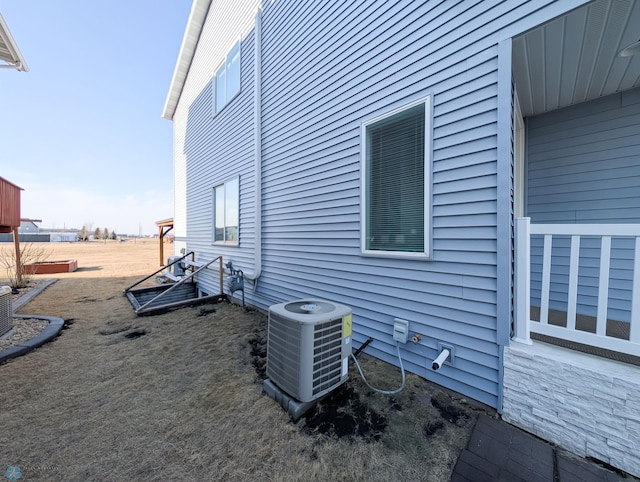 view of side of home featuring central AC