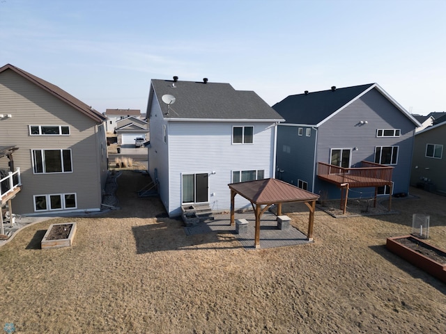 back of property featuring a gazebo, entry steps, and a patio