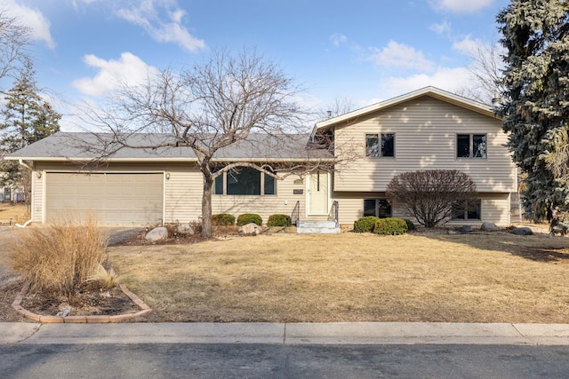 split level home featuring a front yard, a garage, and driveway