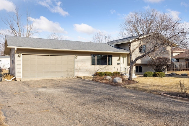 split level home with driveway and a garage