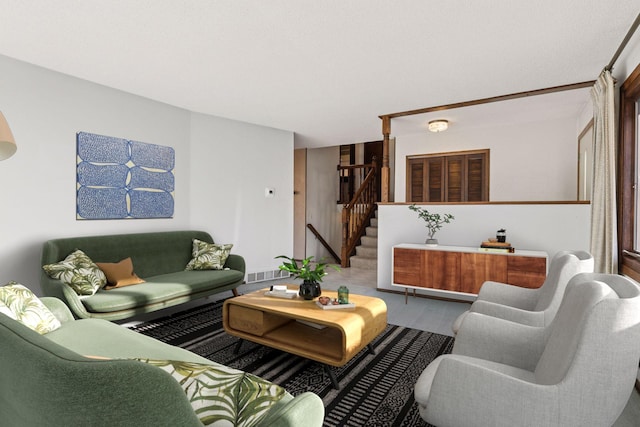 living area featuring visible vents, wood finished floors, and stairway