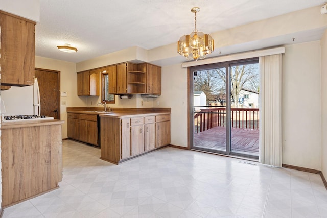 kitchen featuring a sink, brown cabinets, white appliances, and open shelves