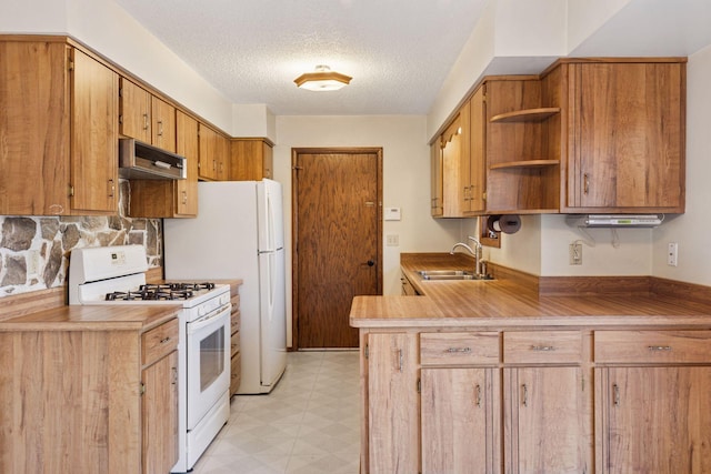 kitchen featuring a sink, open shelves, under cabinet range hood, light floors, and white range with gas stovetop