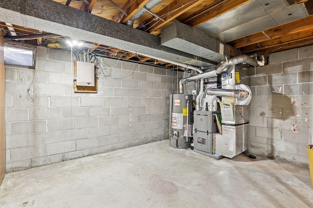 unfinished below grade area featuring electric panel, heating unit, and water heater