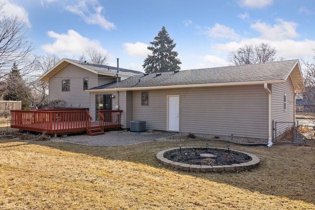 back of house featuring a deck, a yard, central AC unit, and fence