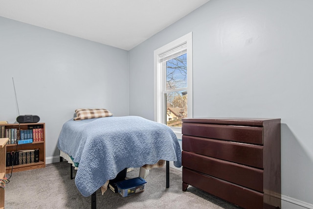 carpeted bedroom featuring baseboards