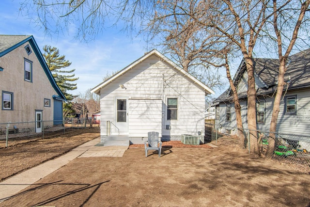 rear view of property with cooling unit and fence