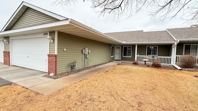 view of front facade featuring driveway, roof with shingles, covered porch, and an attached garage