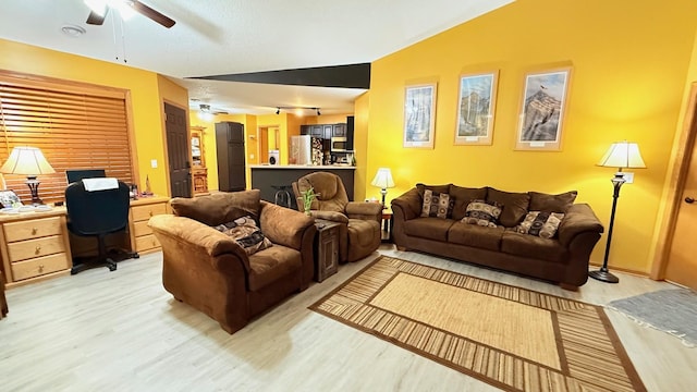 living room featuring light wood-type flooring and a ceiling fan