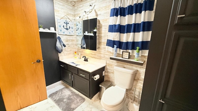 bathroom featuring vanity, toilet, and marble finish floor