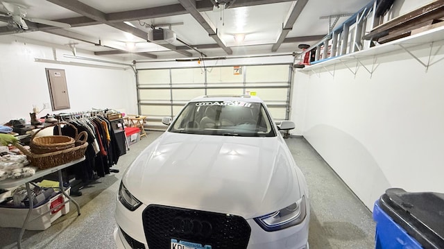 garage with electric panel and a garage door opener