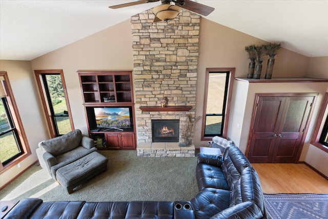 living room with a fireplace, lofted ceiling, a ceiling fan, and wood finished floors