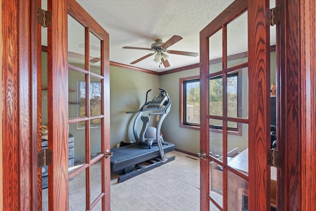 workout room with carpet, ceiling fan, ornamental molding, french doors, and a textured ceiling