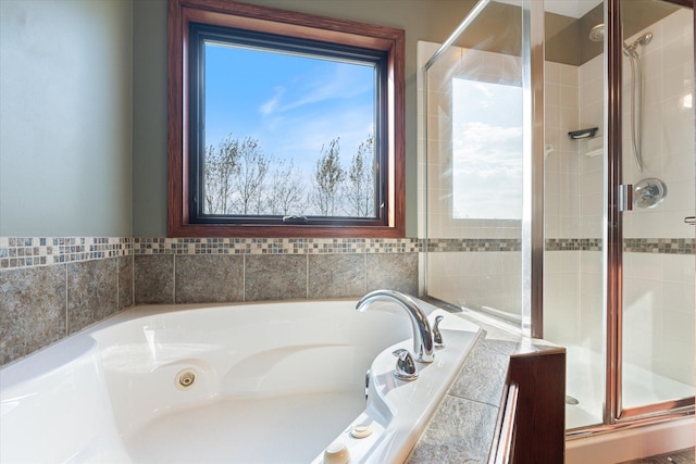 bathroom featuring a bath and a stall shower