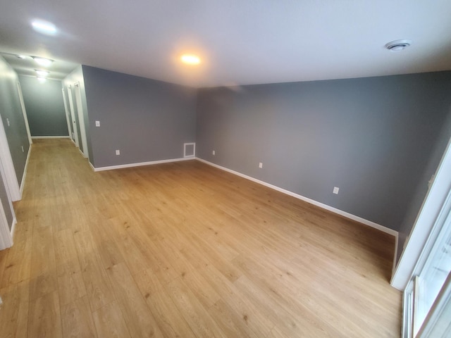 unfurnished room featuring visible vents, baseboards, and light wood finished floors