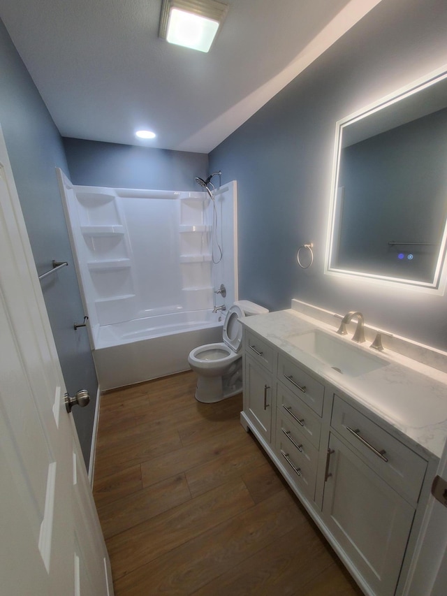 full bath with vanity, toilet, shower / bath combination, and wood finished floors