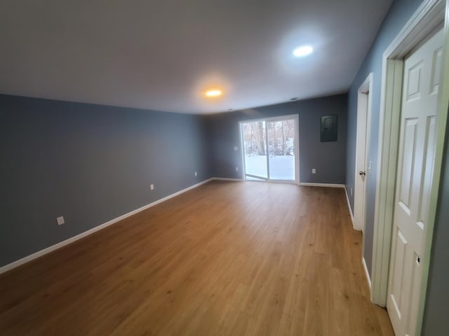 empty room with light wood-type flooring and baseboards