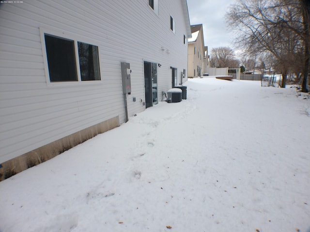 snowy yard with central AC