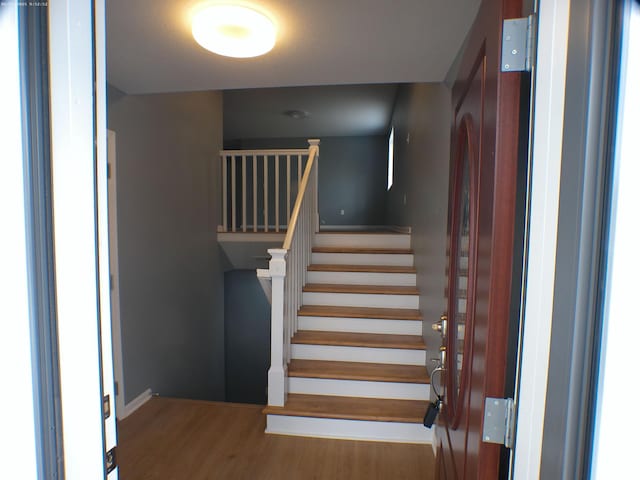 stairway featuring wood finished floors