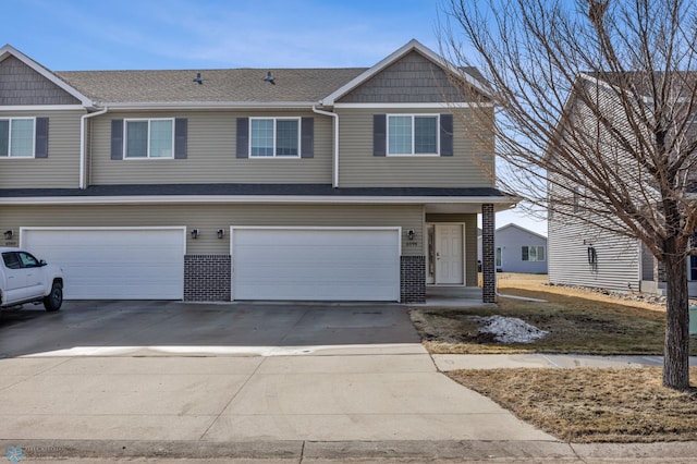 6098 55th Ave S, Fargo, ND 58104 - view of front facade with a garage, concrete driveway, and a shingled roof