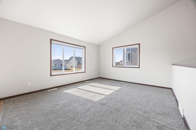 6098 55th Ave S, Fargo, ND 58104 - carpeted empty room with lofted ceiling, visible vents, and baseboards