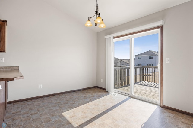 6098 55th Ave S, Fargo, ND 58104 - unfurnished dining area featuring a chandelier, baseboards, and vaulted ceiling