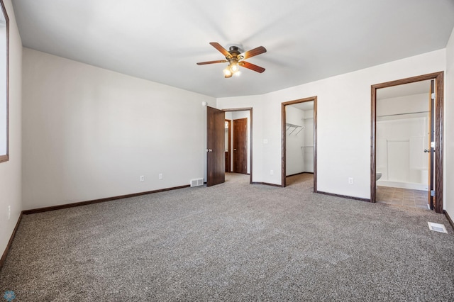 6098 55th Ave S, Fargo, ND 58104 - unfurnished bedroom featuring visible vents, carpet floors, baseboards, and a walk in closet