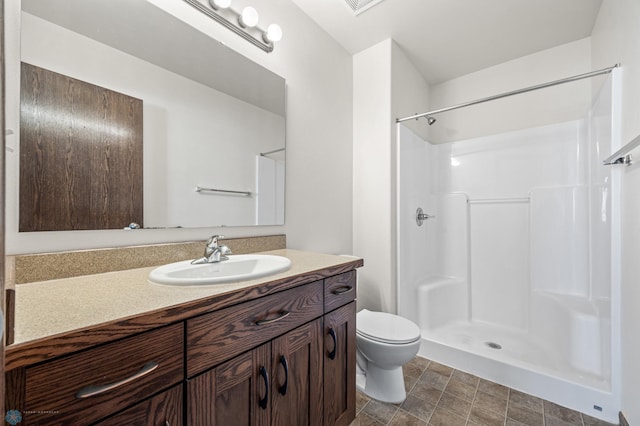 6098 55th Ave S, Fargo, ND 58104 - bathroom featuring a shower, toilet, and vanity
