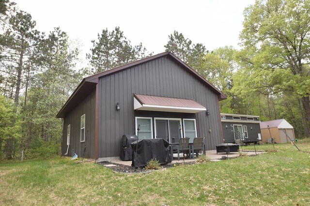 30349 Johnson Creek Trl, Webb Lake, WI 54830 - rear view of property with a patio area, a yard, a shed, and board and batten siding