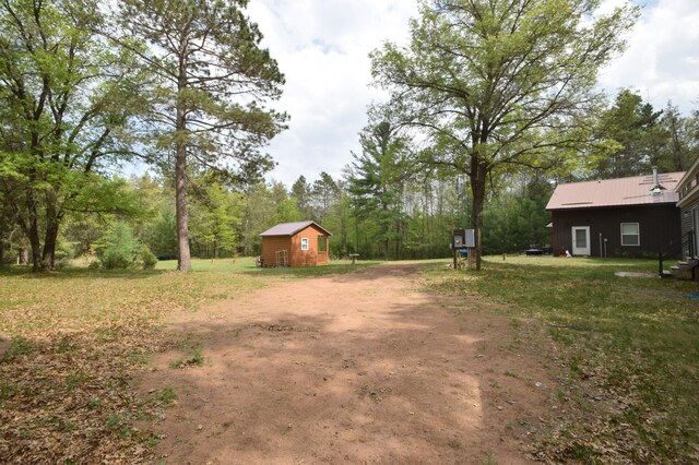 30349 Johnson Creek Trl, Webb Lake, WI 54830 - view of yard featuring an outdoor structure and driveway