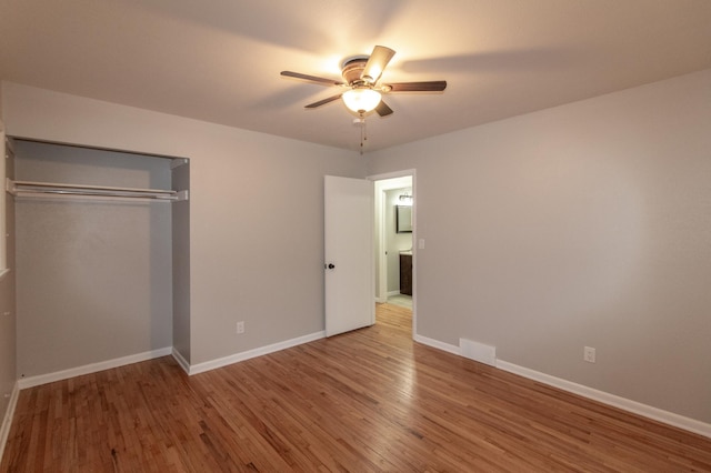 unfurnished bedroom with baseboards and wood finished floors