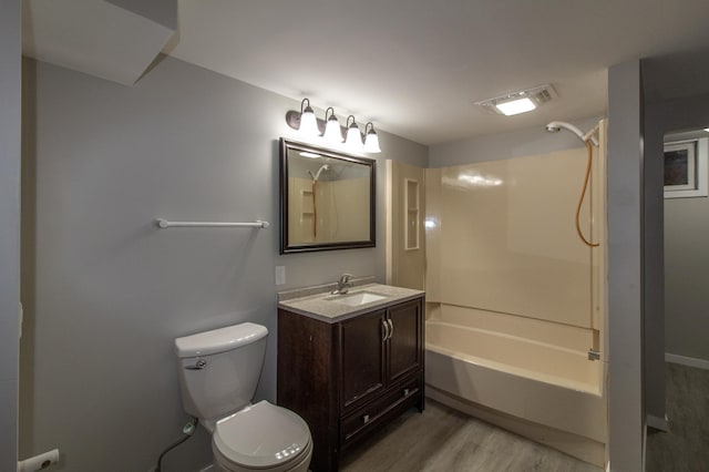 bathroom with visible vents, toilet, shower / bath combination, wood finished floors, and vanity