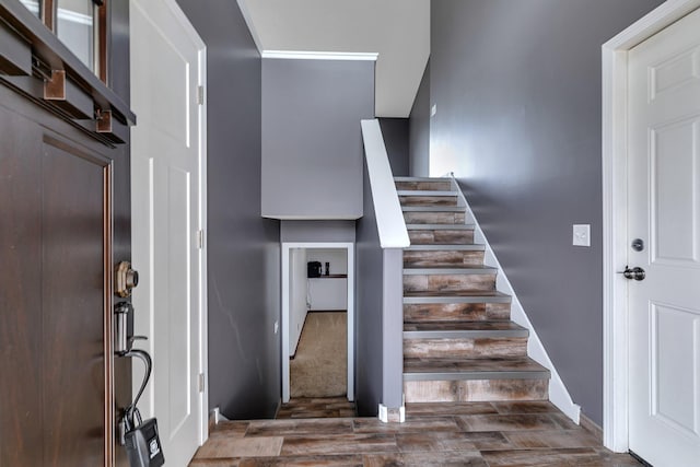 staircase featuring wood finished floors