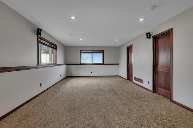 spare room with visible vents, recessed lighting, baseboards, and carpet