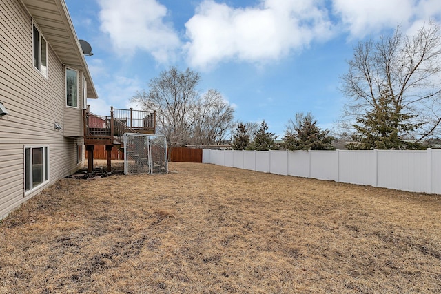 view of yard with stairway, a fenced backyard, and a wooden deck