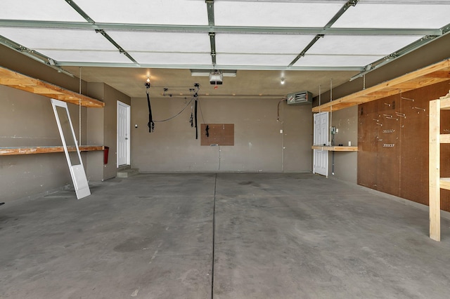 garage with a workshop area and a garage door opener