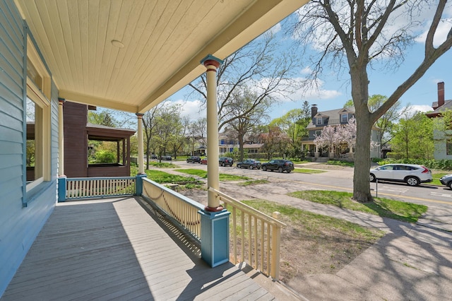 deck with covered porch and a residential view